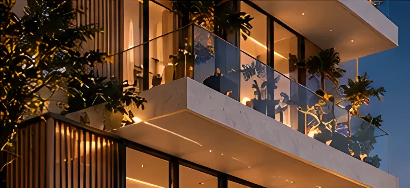 Residence 3B: corner terraces with glass balustrades and planting, lit at dusk