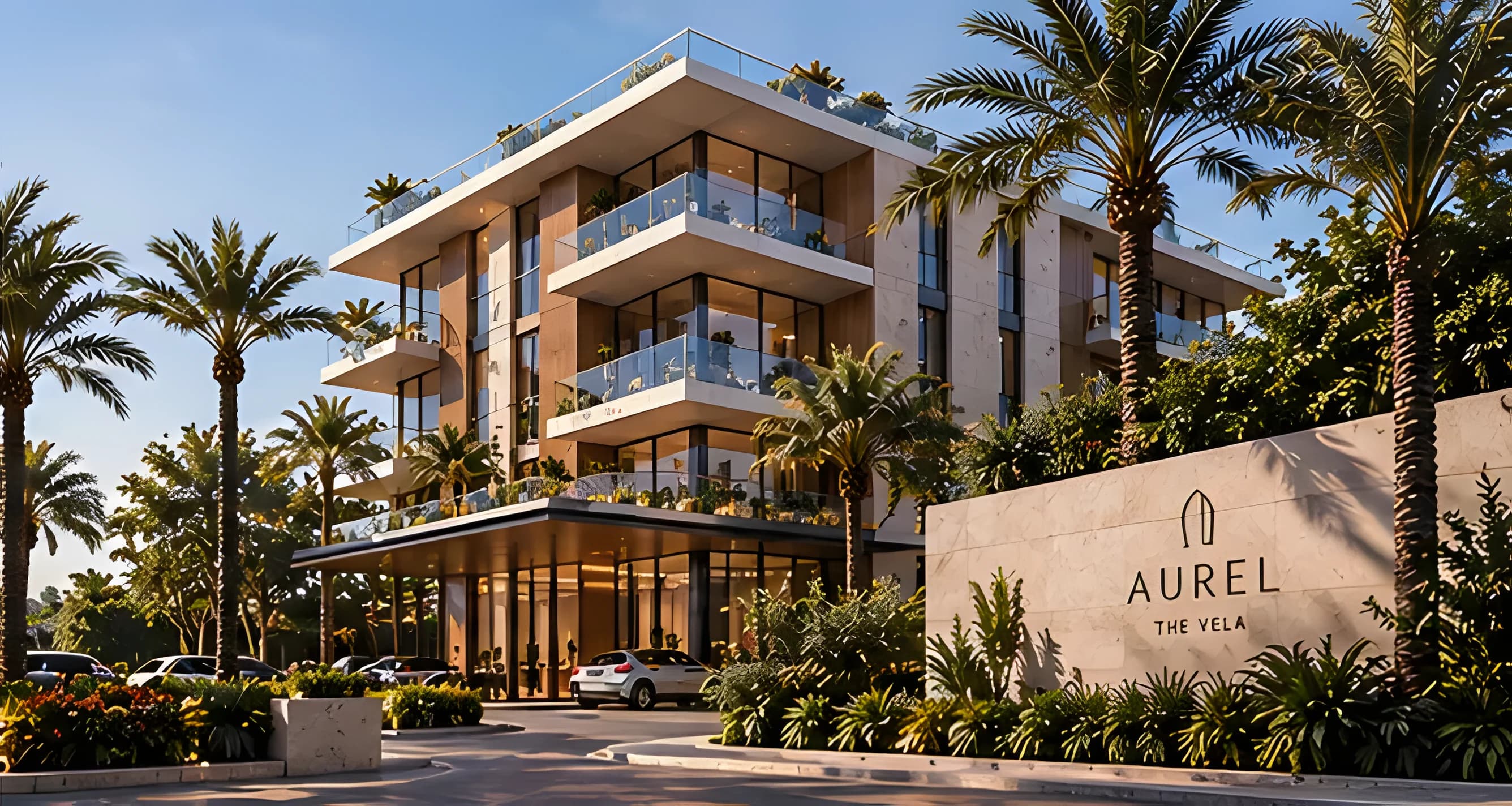 The Vela by day: stacked white terraces with glass balustrades, palms, and the AUREL sign at the entrance